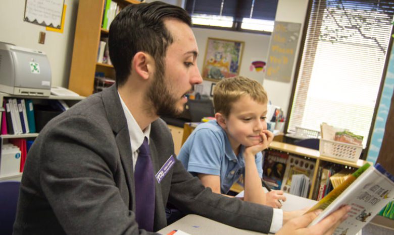 student reading with faculty or staff