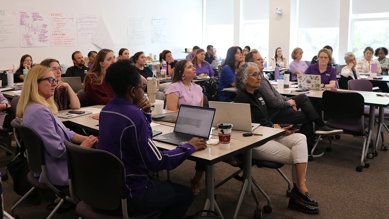 A group of faculty attend a talk about data in a College of Education classroom
