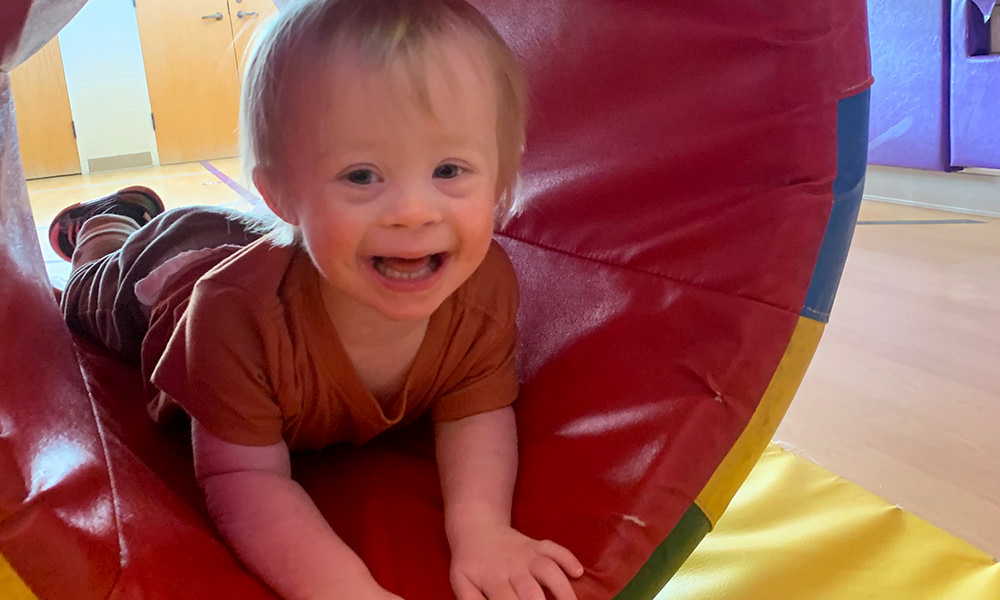 boy playing in tube