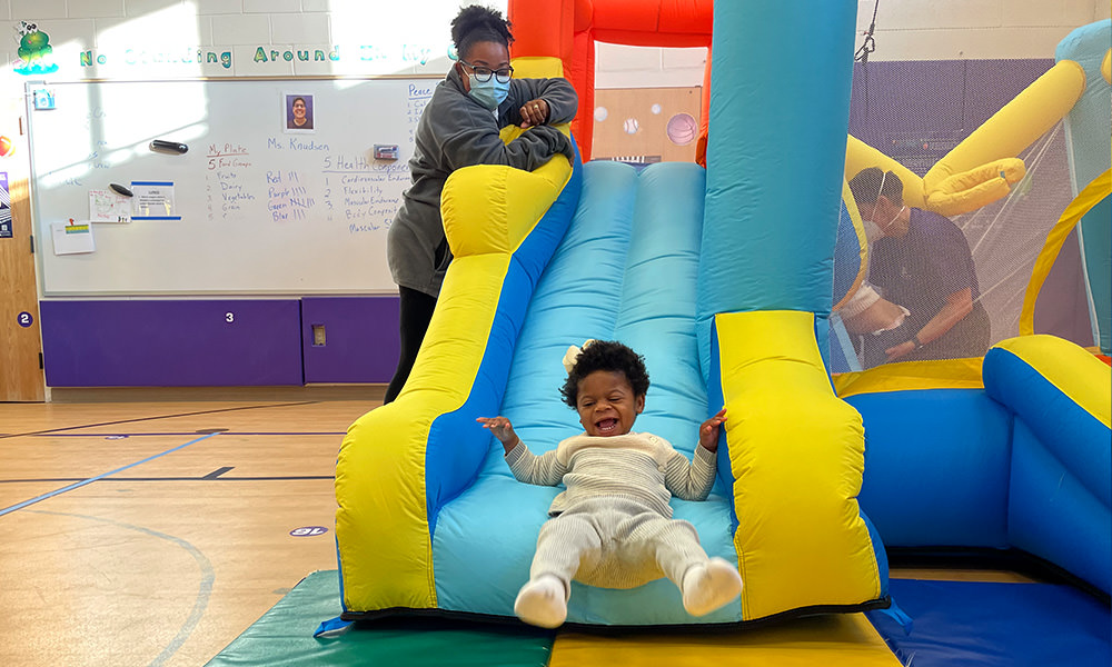 girl playing on slide