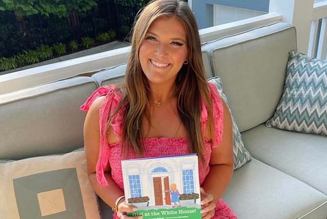 Gigi McBride holding her book. 