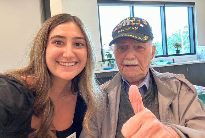 M.Ed. student Gina LeCause '25 with Holocaust survivor Bill Orlin.