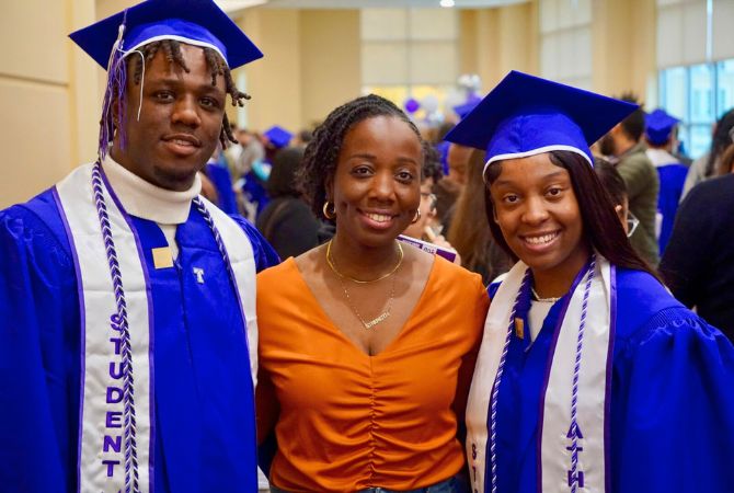 Far Right: Mariah Roberts smiling with another graduate and guest